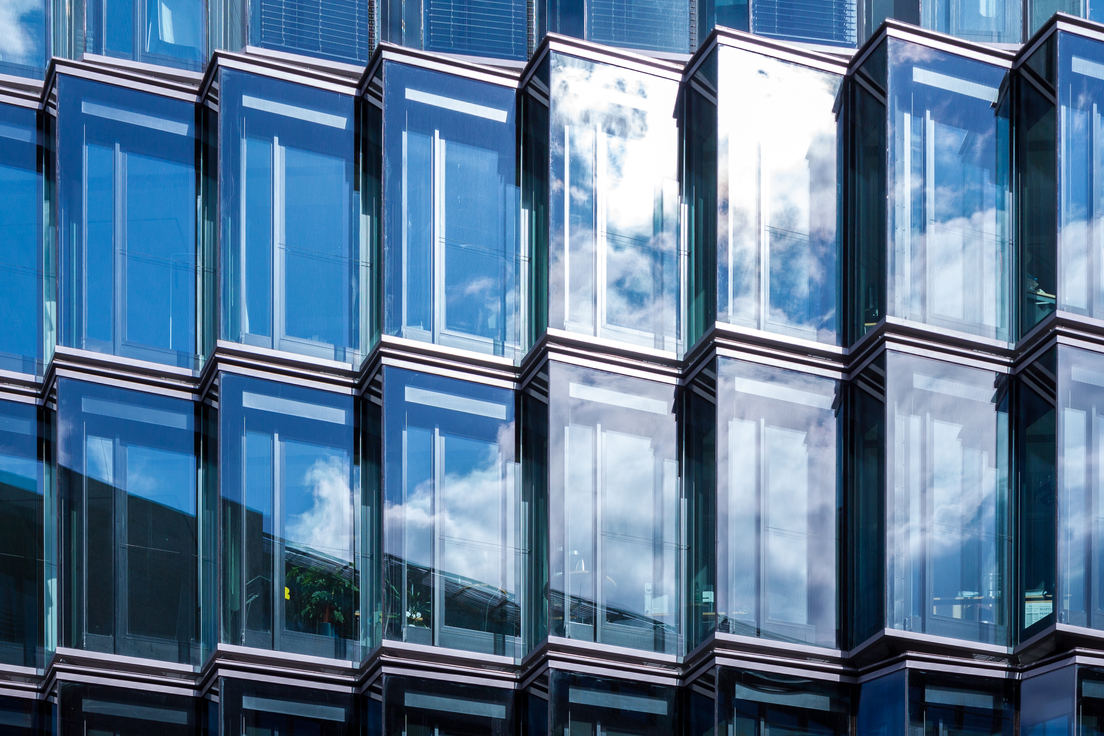 Glass facade of an office building, evoking central bank institutions